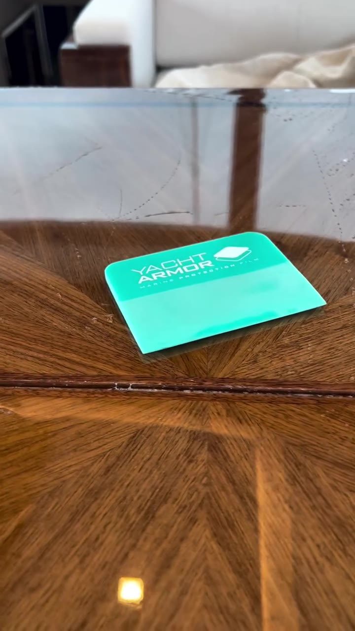 Yacht Armor branded squeegee on teak yacht table installation