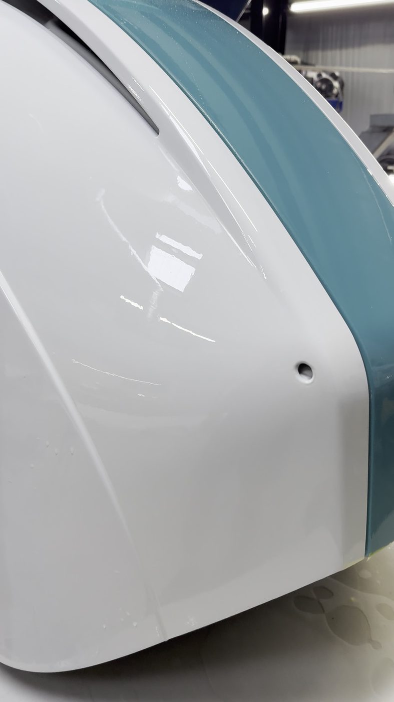 Glossy yacht hull protected with Yacht Armor marine paint protection film